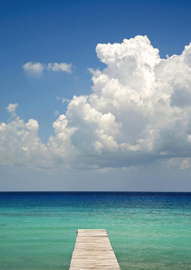 Dock leading to blue green waters in Mexico