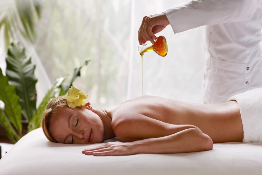 woman serenely lying on massage table receiving spa services