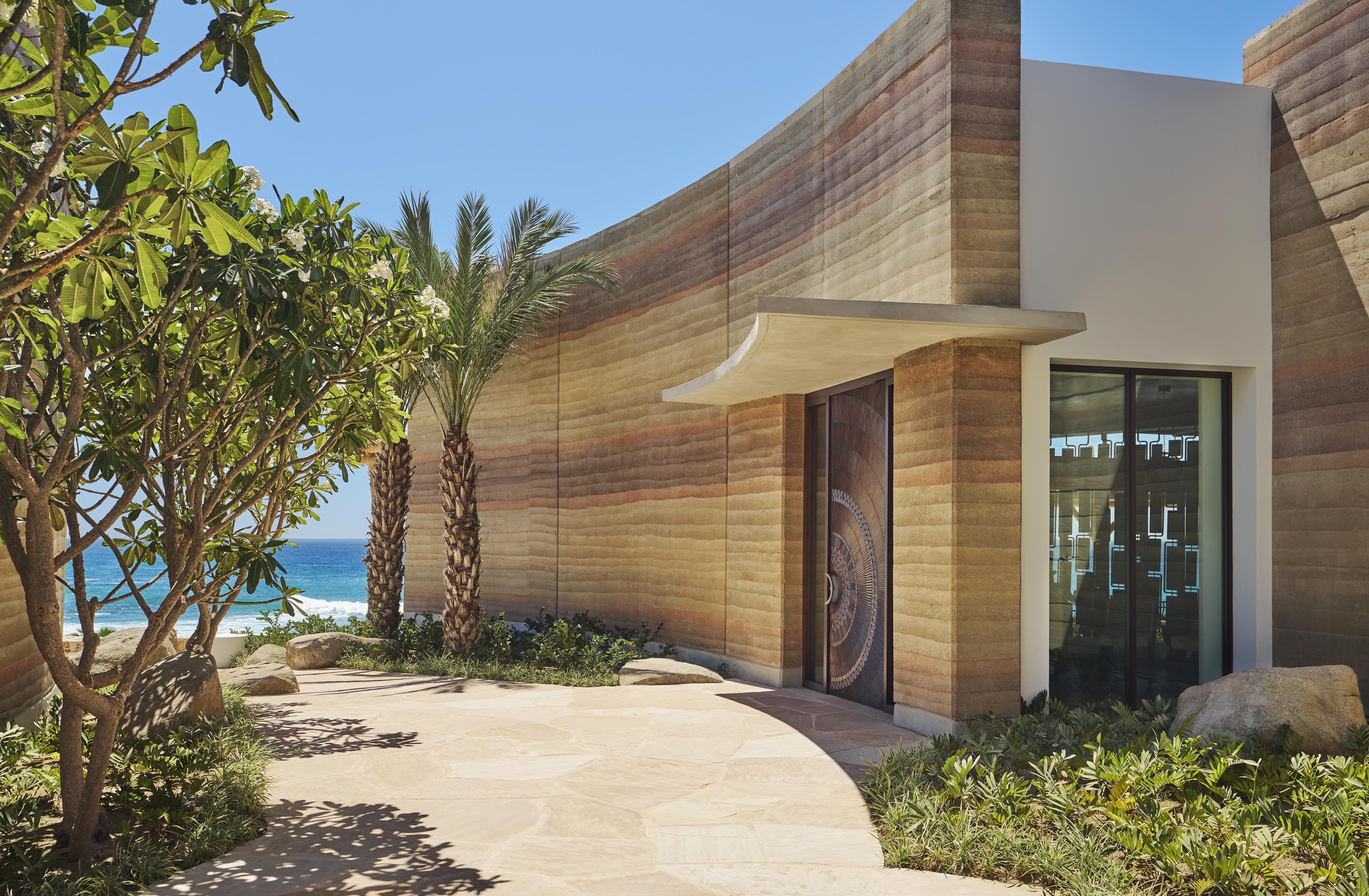 Cove Club Cabo Del Sol architectural entry with landscaping and Baja coastline