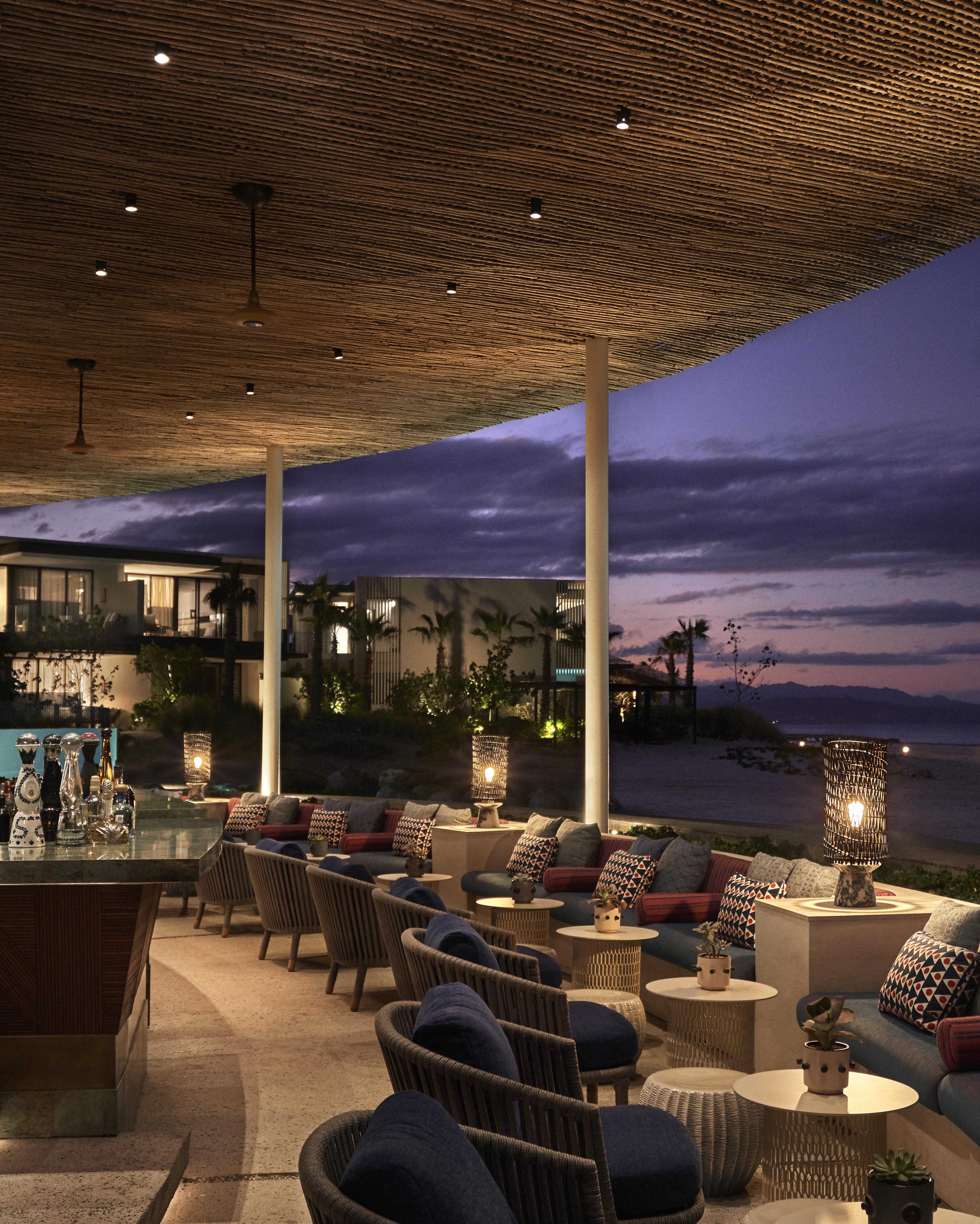 waterfront open air luxury dining space at dusk