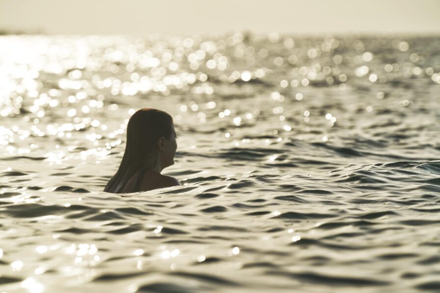 A silhouette of swimmer in golden light in Sea of Cortez