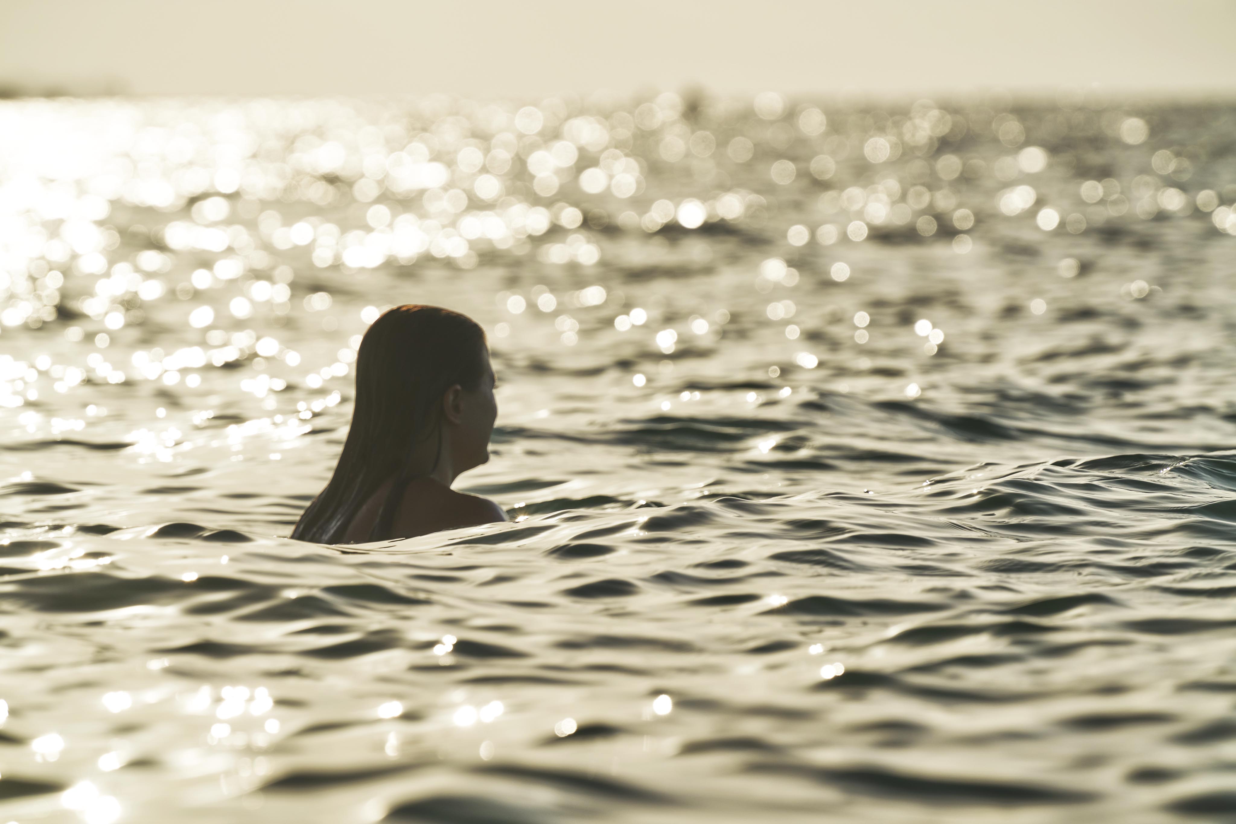 A silhouette of swimmer in golden light in Sea of Cortez