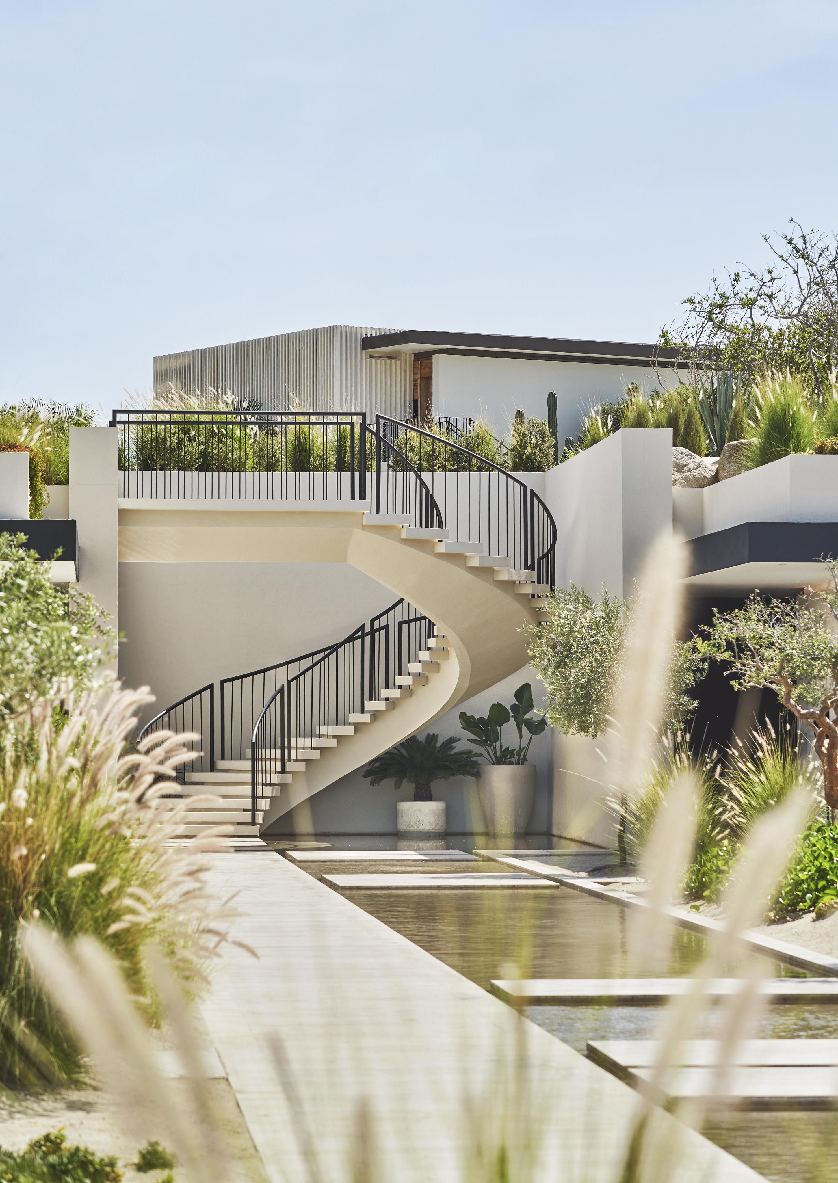 Four Seasons Los Cabos desert inspired spa courtyard architecture with spiral staircase and reflection pool.