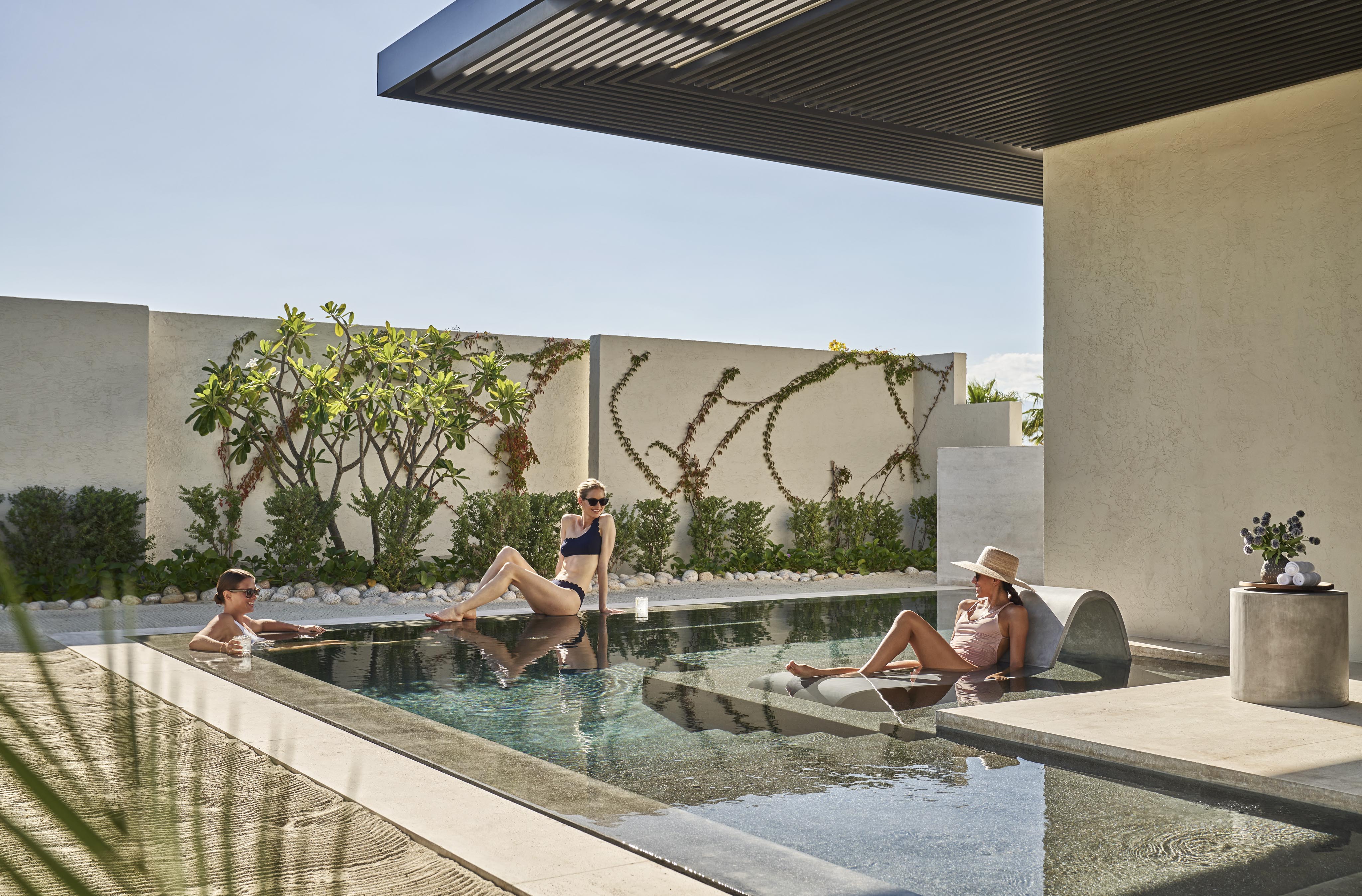 Three women lounging in private Four Seasons Los Cabos at Costa Palms exclusive luxury spa pool and desert oasis.