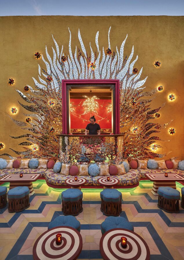 Custom mosaic tiled exterior walls and brightly colored Four Season Los Cabos at Costa Palmas bar space with DJ in center.