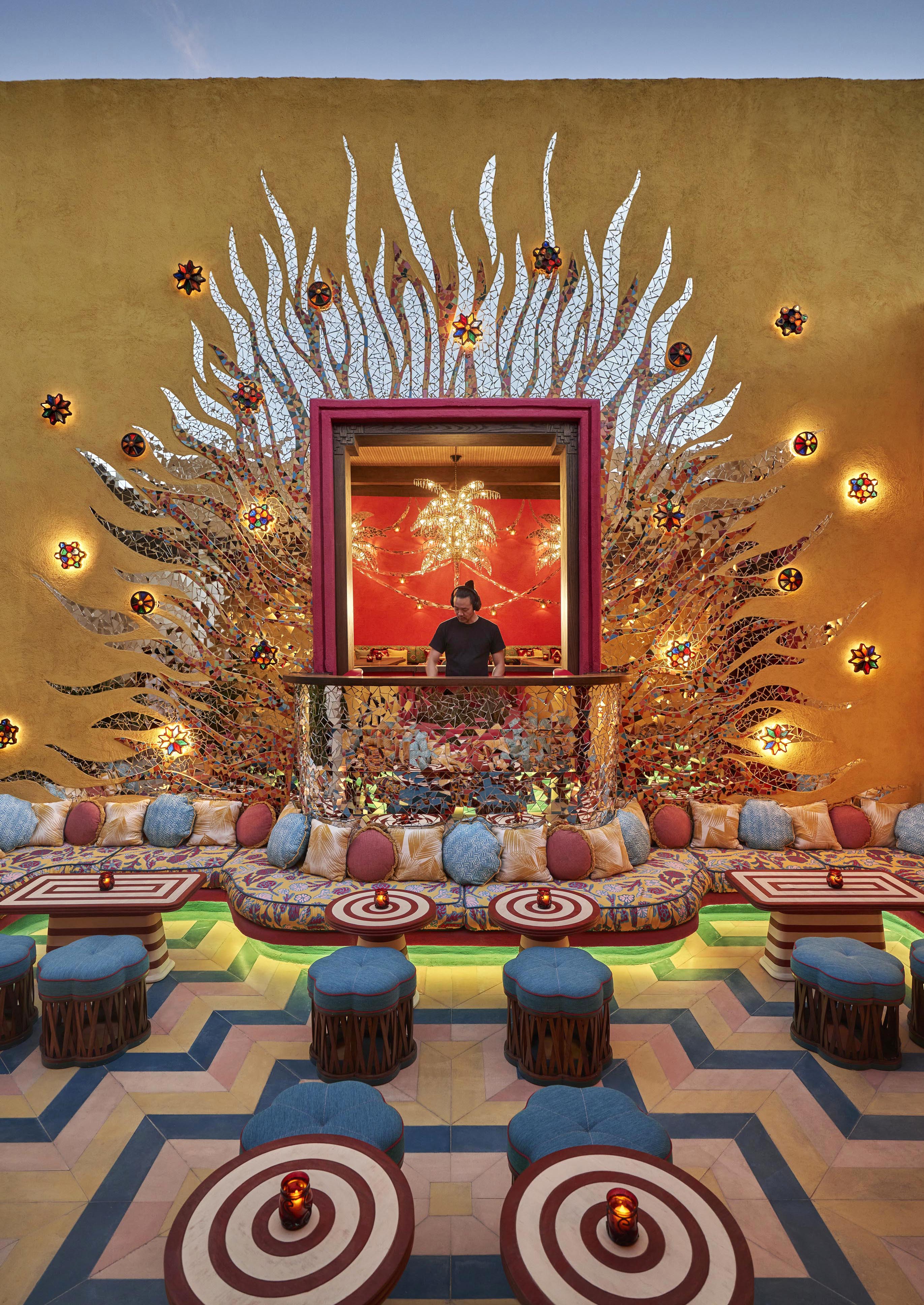 Custom mosaic tiled exterior walls and brightly colored Four Season Los Cabos at Costa Palmas bar space with DJ in center.