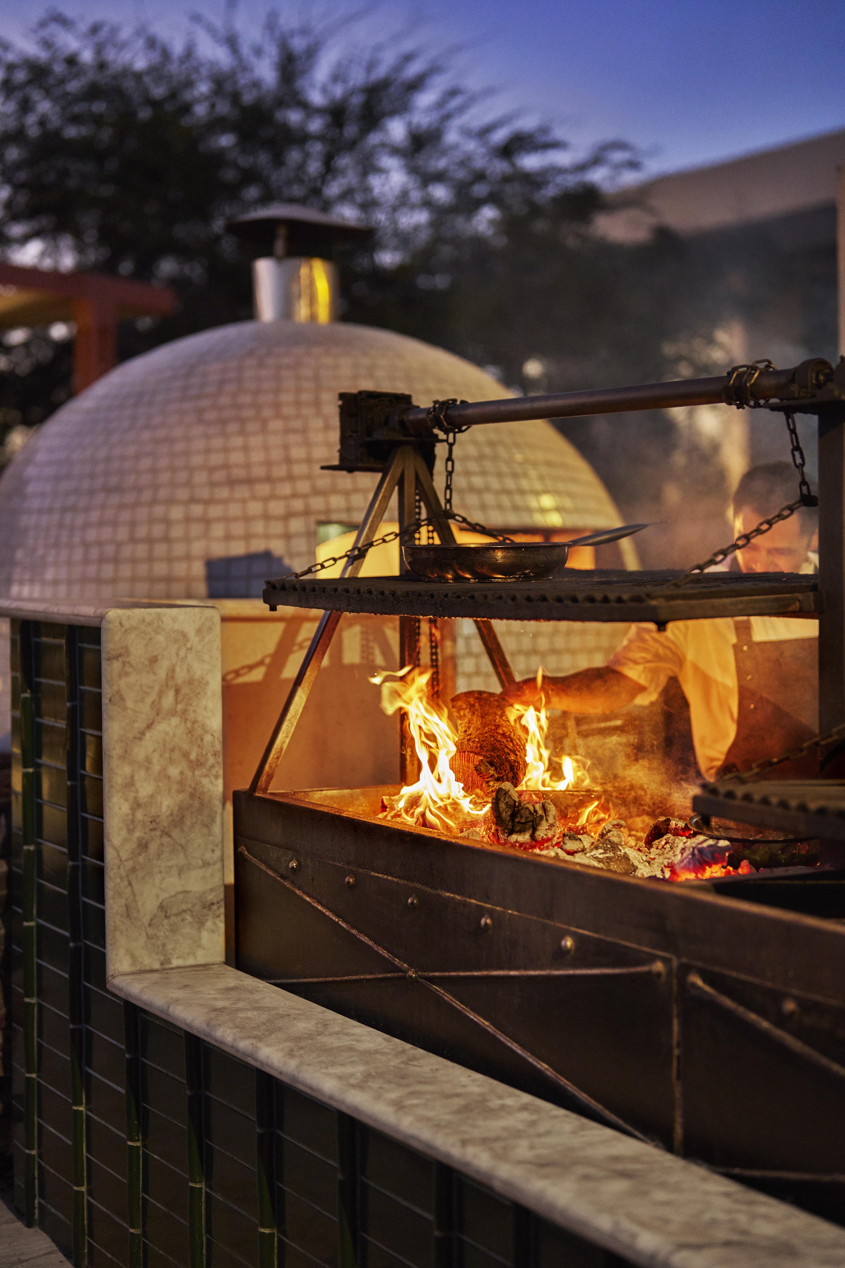 Detail of outdoor adobe style kitchen of Four Seasons Los Cabos at Costa Palmas at dusk