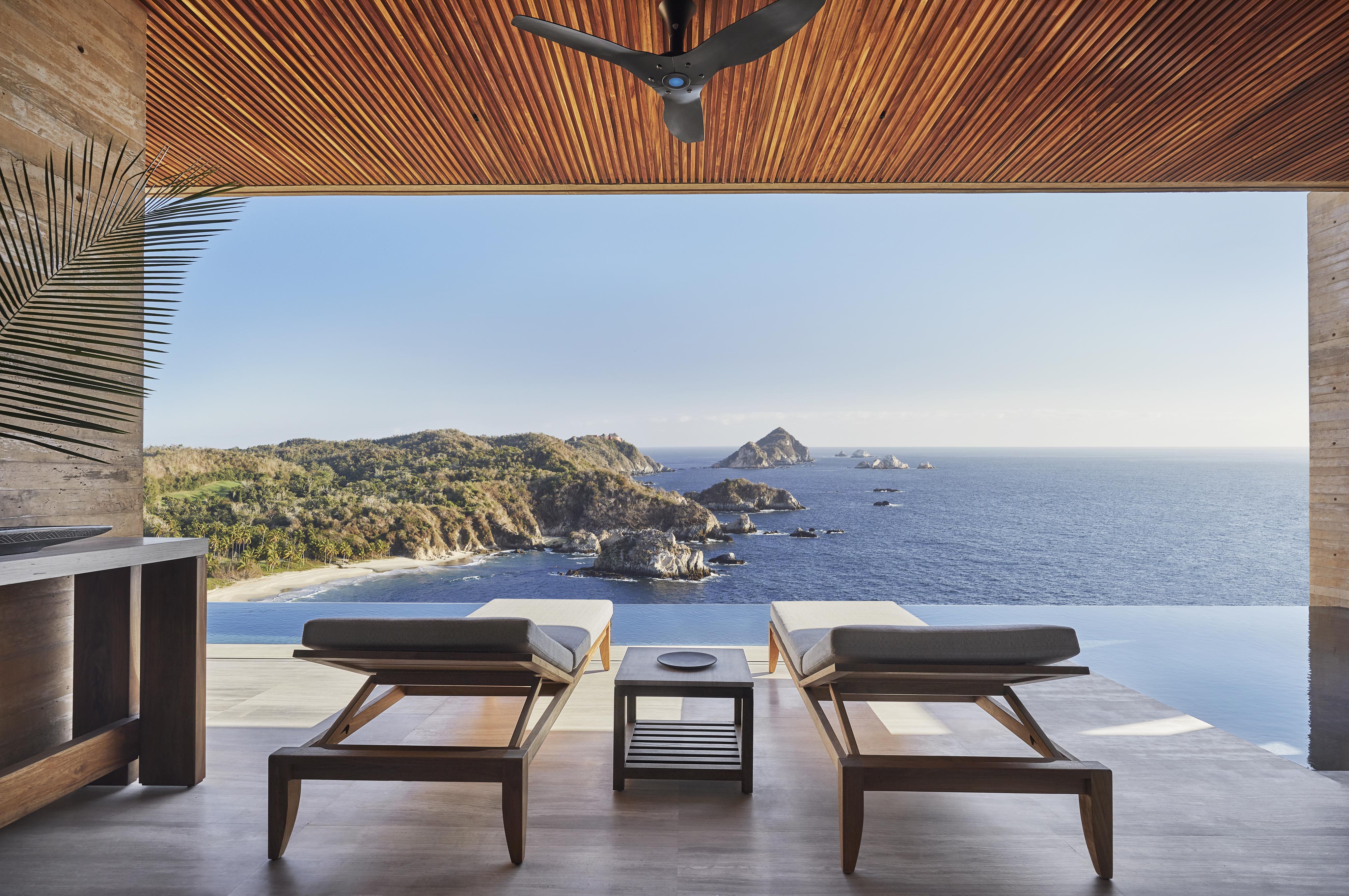 Open air luxury Four Seasons Tamarindo patio with chaise lounge and ocean view