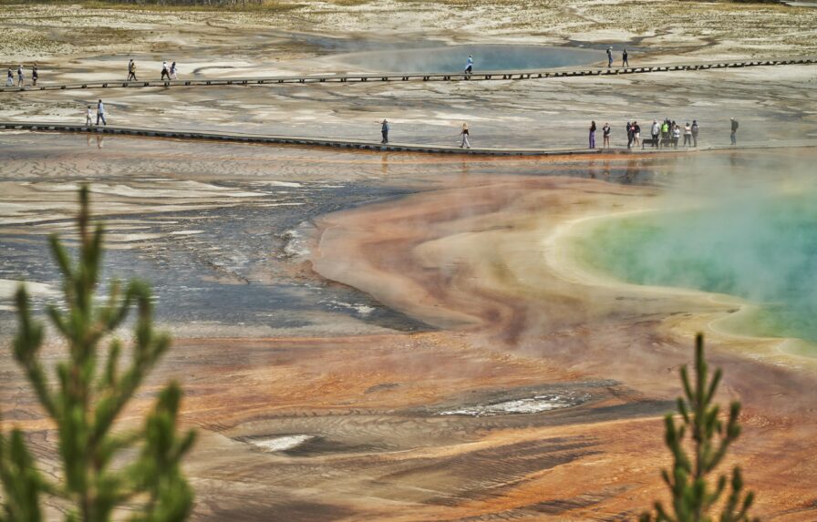 People walking over Old Faithful Yellowstone park
