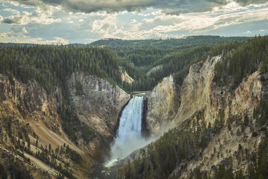 Landscape view rushing waterfall mountainside Yellowstone Park Montana