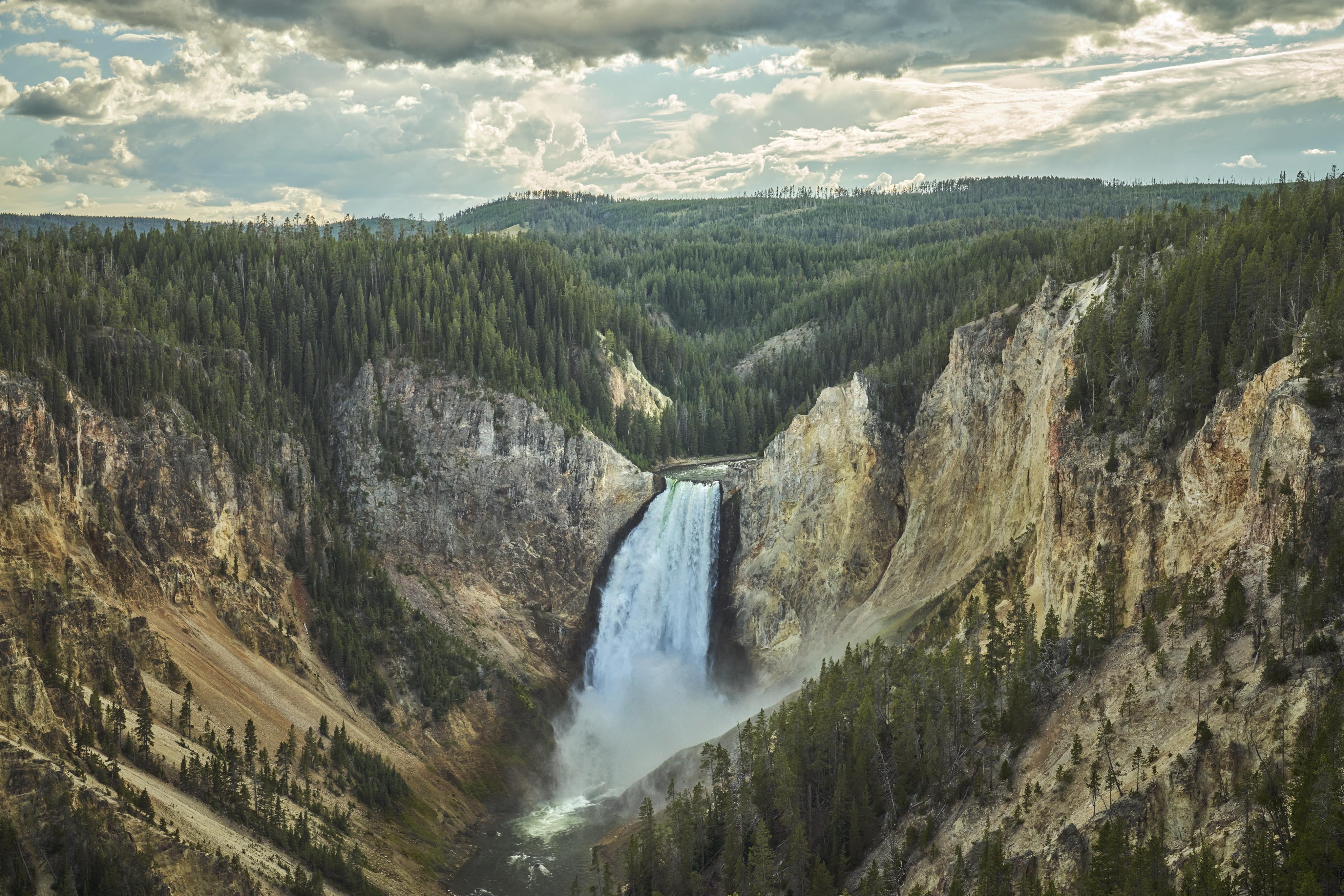Landscape view rushing waterfall mountainside Yellowstone Park Montana