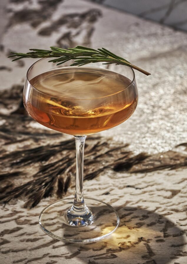 Luxury cocktail service at Montage Big Sky mountain resort garnished with elegant fresh rosemary.