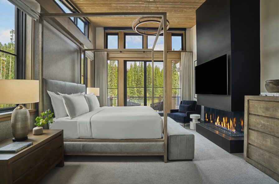 Mountain luxury ski resort suite interior fireplace king bed