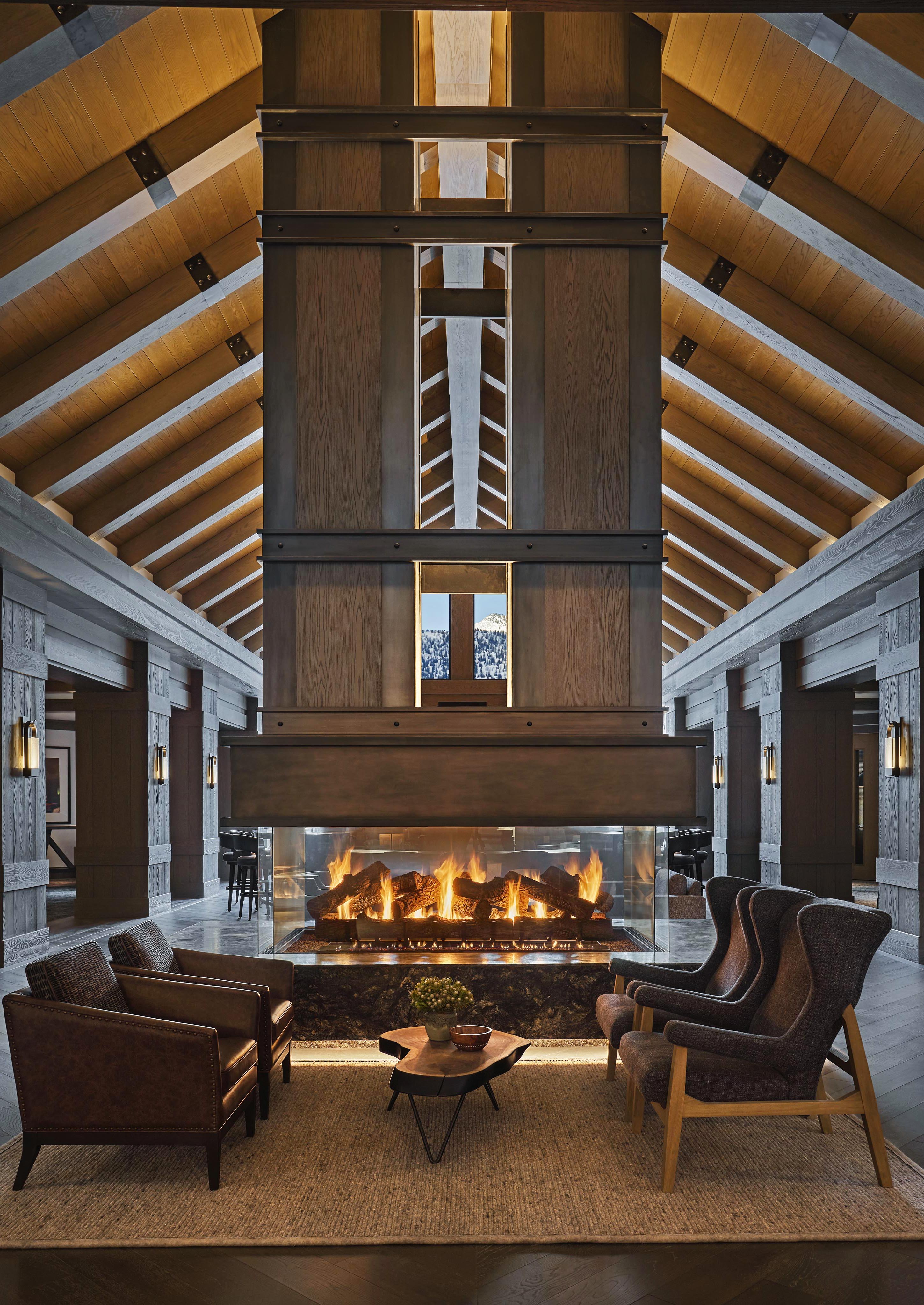 Montage Big Sky resort Alpenglow sitting area featuring modern fireplace, vaulted ceiled and cozy wood interior.