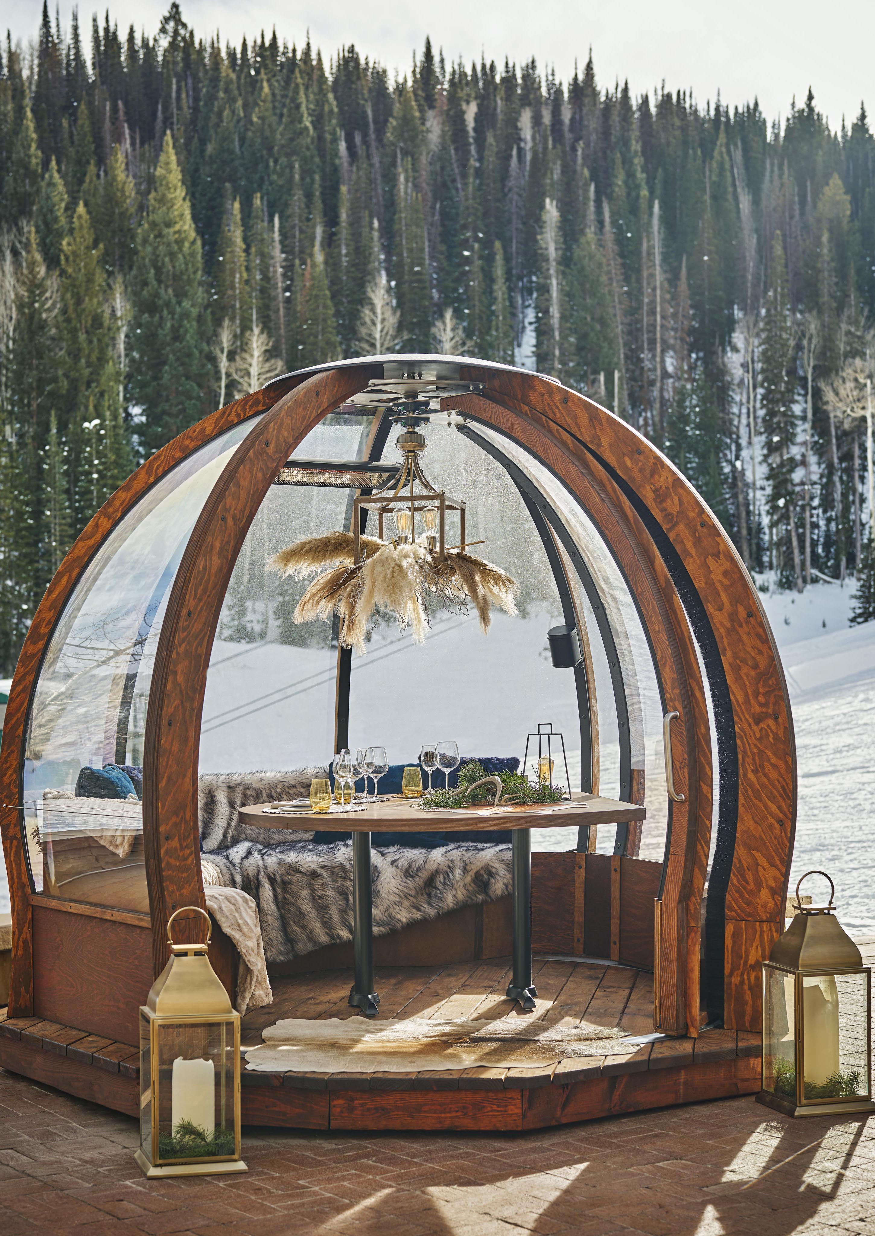 Exclusive outdoor deck dining area nestled in luxury Montage Deer Valley mountain ski resort surrounded by pine trees