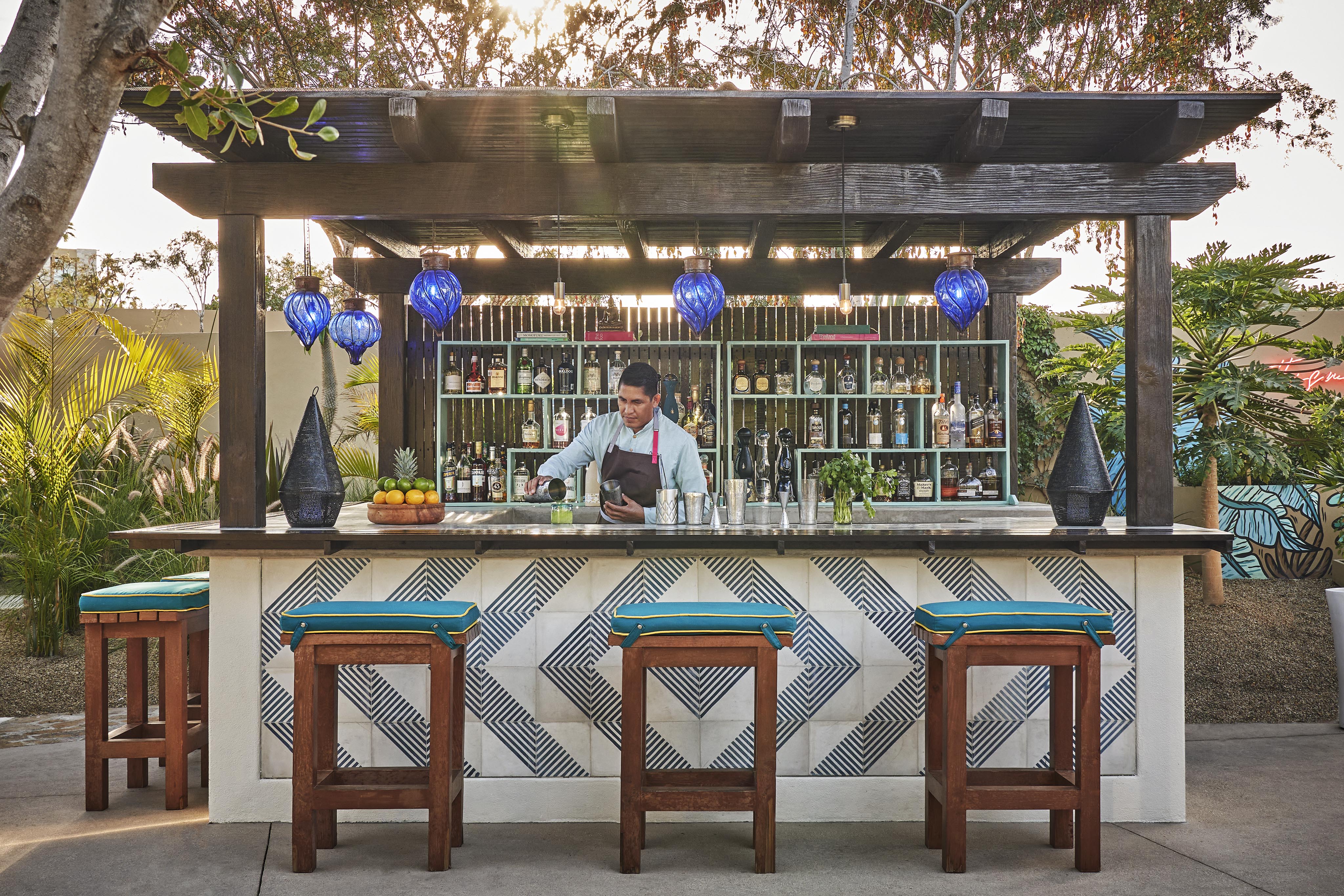 hospitality staff portrait at outdoor bar late afternoon
