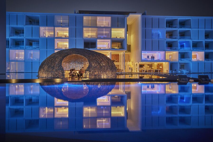 wide view los cabos hotel structure exterior thatched bar structure surrounded by water