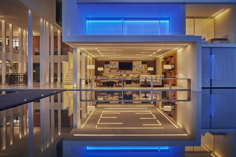 unique block architecture structure with white and blue LED lighting; captured at night.