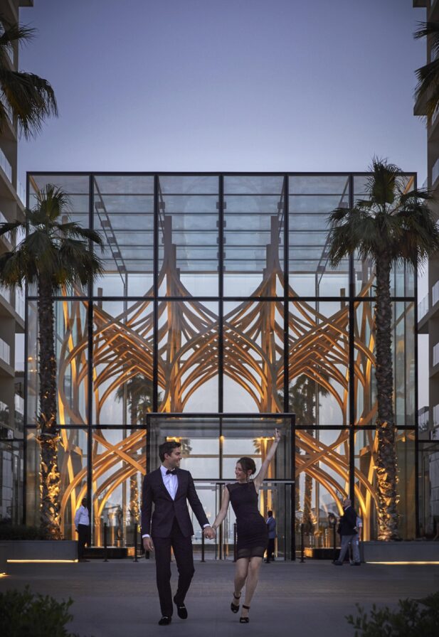 Couple walking from building at dusk