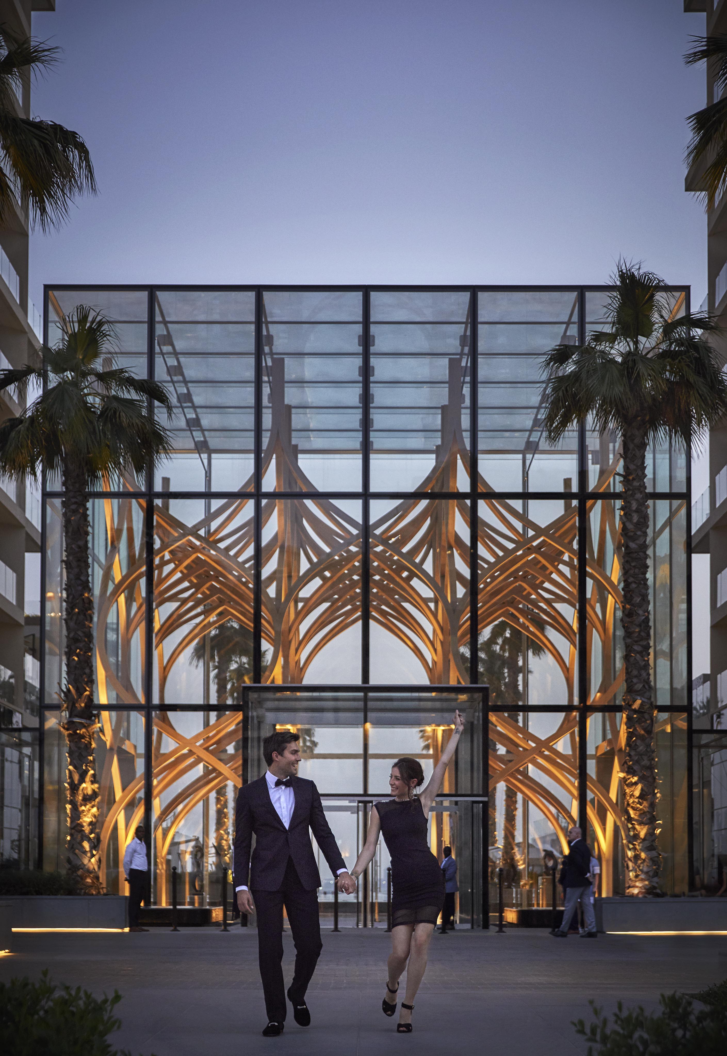 Couple walking from building at dusk