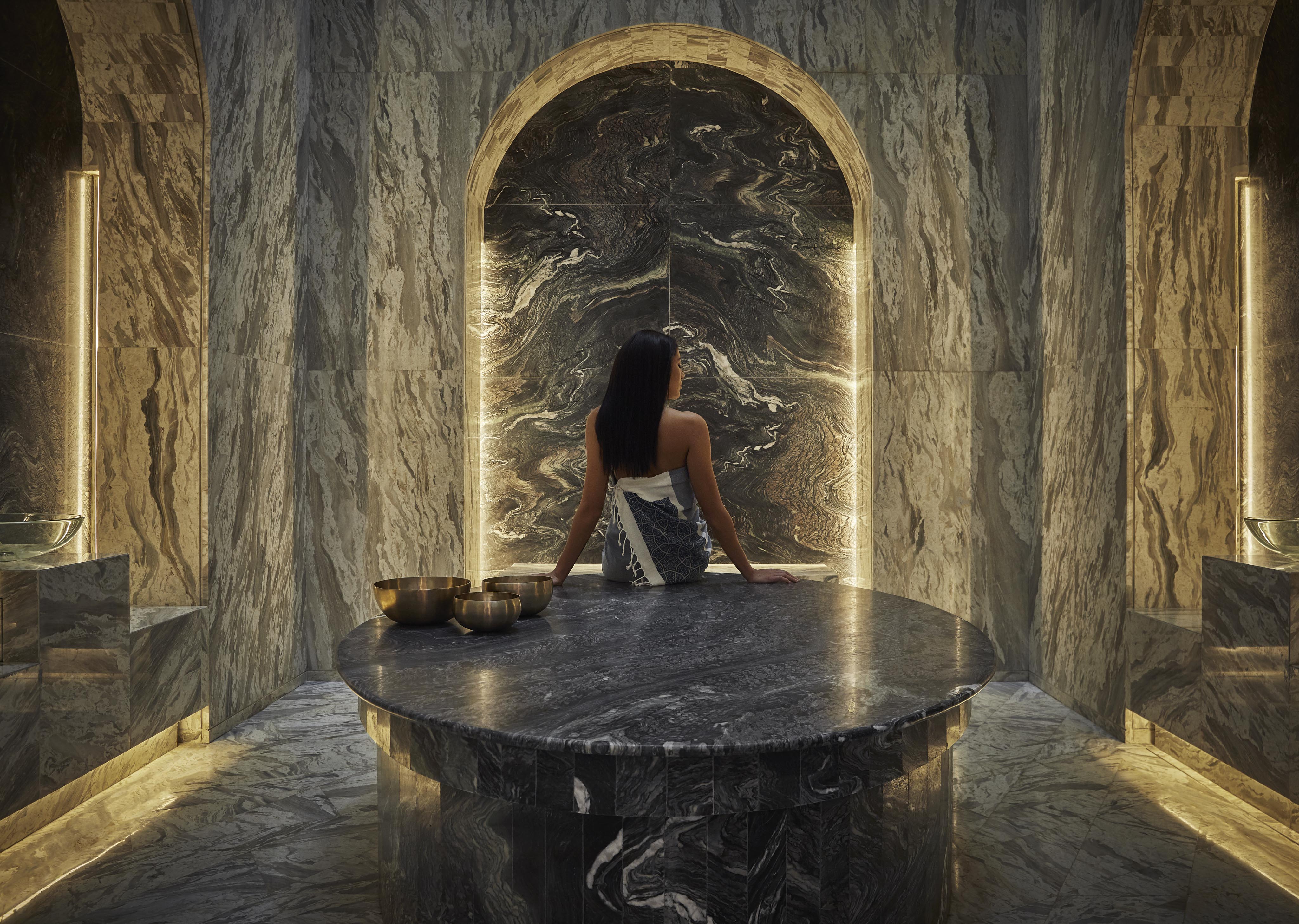 Woman sitting marble round table luxury marble spa room